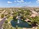 Aerial view of a lush community with ponds, mature trees, and beautiful homes, highlighting the serene environment at 3654 E San Pedro Pl, Chandler, AZ 85249