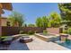 Outdoor living space with a pool, hot tub, fire pit and outdoor seating area at 3654 E San Pedro Pl, Chandler, AZ 85249