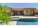 Spacious backyard with a pool, covered patio, lush landscaping and desert plants at 3654 E San Pedro Pl, Chandler, AZ 85249