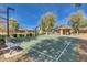 Community basketball court and playground with shade structure in well-maintained park at 3654 E San Pedro Pl, Chandler, AZ 85249