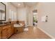 Bright bathroom with a soaking tub, tiled floors, and windows allowing natural light at 3654 E San Pedro Pl, Chandler, AZ 85249