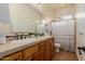 Bright bathroom features a dual-sink vanity with tile countertops and a shower with a white curtain at 3654 E San Pedro Pl, Chandler, AZ 85249