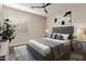 Comfortable bedroom featuring a gray upholstered bed frame, matching decor, and a large window at 3654 E San Pedro Pl, Chandler, AZ 85249