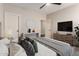 Bright bedroom with a comfortable bed, stylish decor, a TV, and dual doors for easy access at 3654 E San Pedro Pl, Chandler, AZ 85249