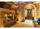 Inviting front entrance with stone archway, wooden door with festive wreath, and cozy fireplace adding charm at 3654 E San Pedro Pl, Chandler, AZ 85249