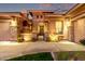 Inviting front exterior with stone accents, arched entryway, and manicured landscaping at 3654 E San Pedro Pl, Chandler, AZ 85249