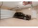 Garage boasts epoxy floors and ample storage, complete with a parked car and overhead storage at 3654 E San Pedro Pl, Chandler, AZ 85249