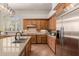 Kitchen featuring stainless steel appliances, an island, and light brown cabinets with granite countertops at 3654 E San Pedro Pl, Chandler, AZ 85249