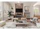 A cozy living room with stone fireplace, built-in shelves, neutral tones, and large windows with shutters at 3654 E San Pedro Pl, Chandler, AZ 85249
