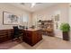 Spacious office area boasts natural light from shuttered windows, a large desk, and built-in shelving at 3654 E San Pedro Pl, Chandler, AZ 85249