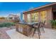 Outdoor kitchen featuring a built-in grill, counter seating, and brick accents, perfect for alfresco dining and entertaining at 3654 E San Pedro Pl, Chandler, AZ 85249
