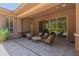 Covered patio area with comfortable seating and view of the lush backyard at 3654 E San Pedro Pl, Chandler, AZ 85249