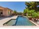 Gorgeous pool with spa and waterfall features surrounded by desert landscaping in backyard at 3654 E San Pedro Pl, Chandler, AZ 85249