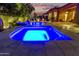 Backyard pool and spa illuminated at dusk, complemented by lush landscaping and outdoor seating at 3654 E San Pedro Pl, Chandler, AZ 85249