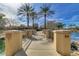 Picturesque walkway over water, lined with palm trees and decorative pillars at 3654 E San Pedro Pl, Chandler, AZ 85249