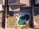 Aerial view of a private backyard featuring a kidney-shaped pool, patio area, and well-maintained landscaping at 41250 W Thornberry Ln, Maricopa, AZ 85138