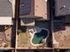 Aerial view of a private backyard featuring a kidney-shaped pool, patio area, and well-maintained landscaping at 41250 W Thornberry Ln, Maricopa, AZ 85138