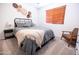 Bedroom with a gray blanket on the bed and a brown chair at 41250 W Thornberry Ln, Maricopa, AZ 85138