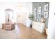 Open hallway features stylish decor, tiled flooring, and seamless transition to other rooms at 41250 W Thornberry Ln, Maricopa, AZ 85138
