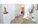 Bright hallway with neutral tile flooring, white doors, and stylish decor leading to a bedroom at 41250 W Thornberry Ln, Maricopa, AZ 85138