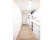 Functional laundry room with white cabinetry, neutral tile, modern appliances, and storage at 41250 W Thornberry Ln, Maricopa, AZ 85138