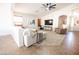 Bright living room with a ceiling fan, TV, modern decor, and comfortable seating area at 41250 W Thornberry Ln, Maricopa, AZ 85138