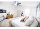 Bright main bedroom with a ceiling fan, TV, carpet and neutral decor at 41250 W Thornberry Ln, Maricopa, AZ 85138