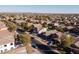 Panoramic aerial view of a peaceful suburban neighborhood featuring diverse homes, lush trees, and well-maintained streets at 41250 W Thornberry Ln, Maricopa, AZ 85138