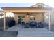 Covered patio area with comfortable seating, a ceiling fan, and a relaxing outdoor living space at 41250 W Thornberry Ln, Maricopa, AZ 85138