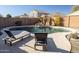 Inviting backyard pool with a rock waterfall feature and comfortable lounge chairs for relaxation at 41250 W Thornberry Ln, Maricopa, AZ 85138