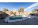 Private backyard pool with a rock waterfall, surrounded by desert landscaping and a peaceful ambiance at 41250 W Thornberry Ln, Maricopa, AZ 85138