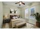 Cozy bedroom with natural light, shutters, neutral decor, patterned rug, and comfortable furnishings at 42988 W Misty Morning Ln, Maricopa, AZ 85138