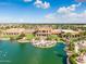 Aerial shot of a community center on a lake with an outdoor patio and well maintained landscaping at 42988 W Misty Morning Ln, Maricopa, AZ 85138
