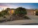 Charming single-story home features a well-manicured desert landscape, a covered entrance, and a two-car garage at 42988 W Misty Morning Ln, Maricopa, AZ 85138