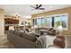 The living room features a ceiling fan, decorative stone, and an open concept layout at 42988 W Misty Morning Ln, Maricopa, AZ 85138