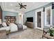 This spacious main bedroom features a ceiling fan, tile floors, and an adjoining bathroom at 42988 W Misty Morning Ln, Maricopa, AZ 85138
