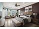 This main bedroom is spacious and bright with a tray ceiling and large windows at 42988 W Misty Morning Ln, Maricopa, AZ 85138