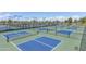 Outdoor pickleball courts with fences and lighting provide ample space for recreational activities at 42988 W Misty Morning Ln, Maricopa, AZ 85138