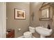 Charming powder room with decorative mirror, vessel sink, and unique artwork for a stylish touch at 42988 W Misty Morning Ln, Maricopa, AZ 85138