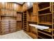 Spacious walk-in closet boasts custom shelving and cabinetry including a built-in ironing board at 42988 W Misty Morning Ln, Maricopa, AZ 85138