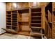 Custom walk-in closet with built-in shelves, drawers, and pull-out baskets for organized storage at 42988 W Misty Morning Ln, Maricopa, AZ 85138