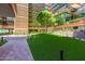 Lush green courtyard with trees, plants, and walkways connecting modern buildings at 4808 N 24Th St # 1402, Phoenix, AZ 85016