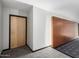 Hallway with neutral paint and a carpet floor design, with a light-colored door at 4808 N 24Th St # 1402, Phoenix, AZ 85016