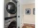 Laundry with a modern front-load washer and dryer, situated beside an open door at 4808 N 24Th St # 1402, Phoenix, AZ 85016