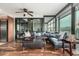 Stylish living room with hardwood floors, sectional sofa, and sliding doors to enclosed patio at 4808 N 24Th St # 1402, Phoenix, AZ 85016