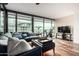 Bright living room features a large sectional, wood floors, and a Peloton bike at 4808 N 24Th St # 1402, Phoenix, AZ 85016