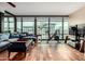 Spacious living room with wood flooring, city views, and comfortable seating at 4808 N 24Th St # 1402, Phoenix, AZ 85016