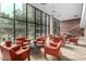 Comfortable lobby area featuring orange chairs, textured carpet, and walls of windows at 4808 N 24Th St # 1402, Phoenix, AZ 85016