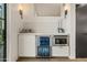 Stylish bar area equipped with a beverage refrigerator, microwave, and marble countertops at 5101 N Casa Blanca Dr # 25, Paradise Valley, AZ 85253