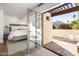 Cozy bedroom flowing out to a terrace featuring seating, a pergola, and lush greenery at 5101 N Casa Blanca Dr # 25, Paradise Valley, AZ 85253
